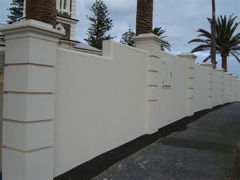 A unique fence is going to create a great impression in your neighborhood and with a cool pallet fence. Solid With Caststone Pillars | Front wall design, Fence ...