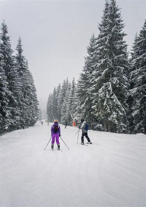 People Skiing On The Snowy Slope Of Bukovel Ski Resort In The Ukrainian