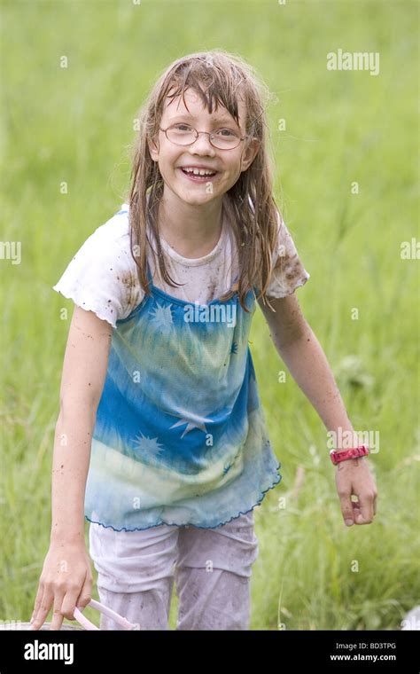 Young Girl Showing Soaking Wet Clothes And Water Dripping From Her