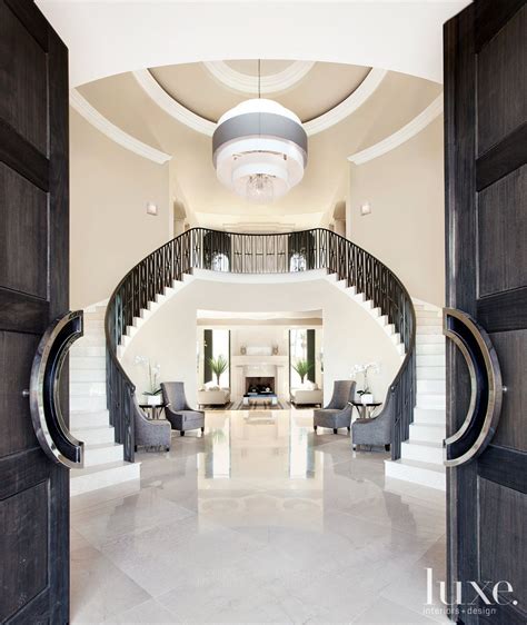 Contemporary White Entry With Double Staircase Luxe Interiors Design