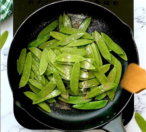 Sugar Snap Peas In A Sautée Pan With Oil Salt And Pepper Side Dish