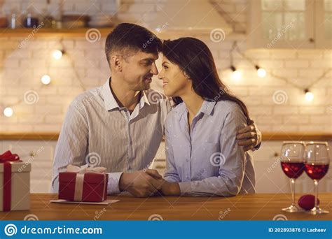 Man And A Woman Holding Hands Tenderly And Lovingly Looking Into Each Other`s Happy Eyes Stock