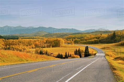 Highway And Distant Mountains With Trees In Alberta, Canada - Stock ...