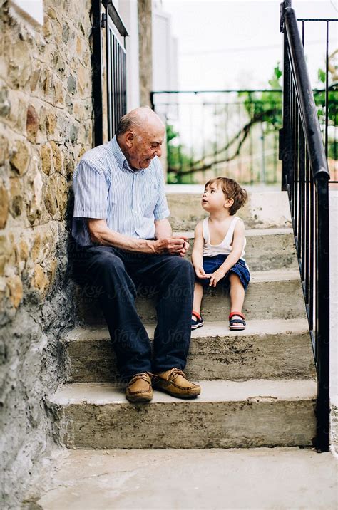 Grandfather Talking To His Grandson Outdoor By Stocksy Contributor