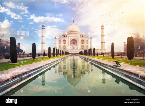 Taj Mahal Tomb With Reflection In The Water At Blue Dramatic Sky In