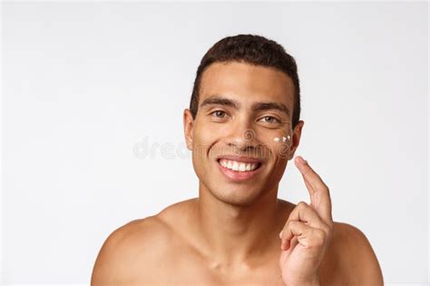 Photo Of Shirtless African American Man Smiling And Applying Face Cream