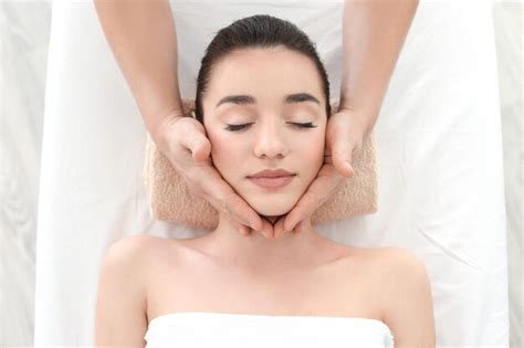 Premium Photo Beautiful Young Woman Receiving Facial Massage In Spa Salon