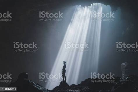 Man Standing In Jomblan Cave In Sunbeams Stock Photo Download Image
