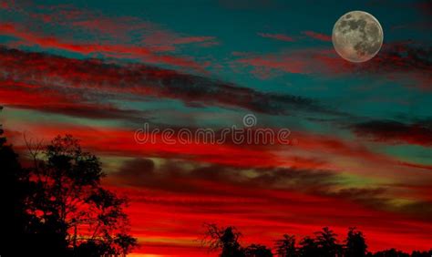 A Partially Full Moon During A Beautiful Sunset Stock Photo Image Of