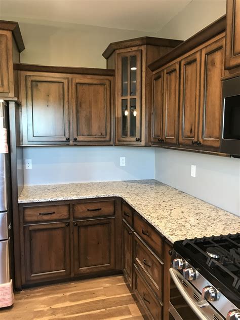 It looks like an espresso colored finish on those floors which could look great with your cabinets. Rustic cherry cabinets with early American stain and espresso glaze finish. Dallas White granite ...
