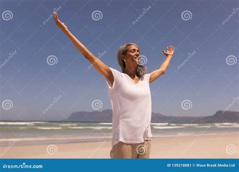 Senior Woman With Arms Outstretched Standing On Beach Stock Image Image Of Outstretched