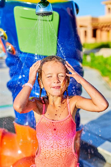 Funny Little Girl In Swimsuit Cooling In Shower Outside Stock Photo By