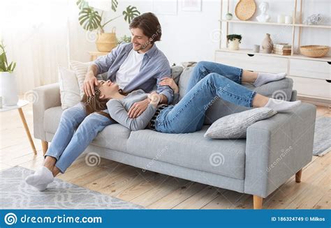 Lovely Young Couple Cuddling On Sofa At Home Stock Image Image Of