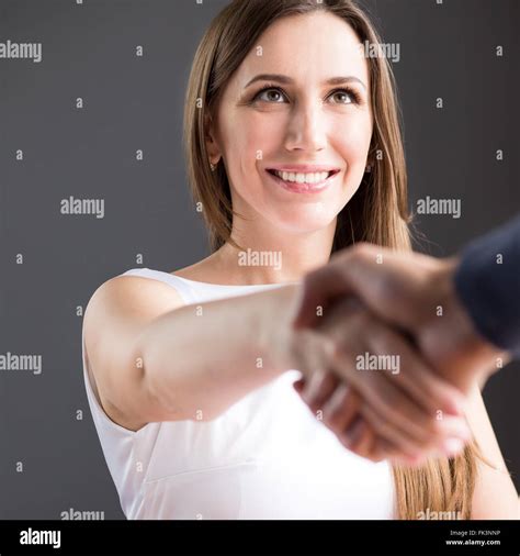 Young Smiling Business Woman In White Smart Dress Shaking Hands With