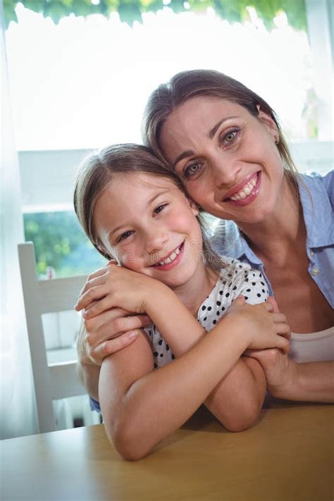Happy Mother And Daughter Embracing At Home Stock Photo Image Of
