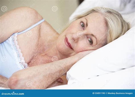 Senior Woman Relaxing On Bed Stock Photo Image Of Pensioner Adult