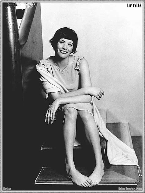 A Black And White Photo Of A Woman Sitting On Stairs