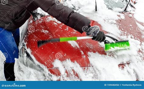 Image Of Lady Clean Up Snow Covered Car By Brush After Blizzard