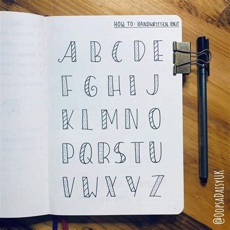 An Open Notebook With Letters And Numbers Written In Cursive Writing On