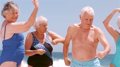 Two Happy Ethnic Retired Couples Having Fun Walking Linked