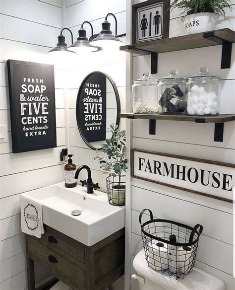 The Bathroom Is Decorated In White And Black With Farmhouse Decor On The Wall Above The Sink