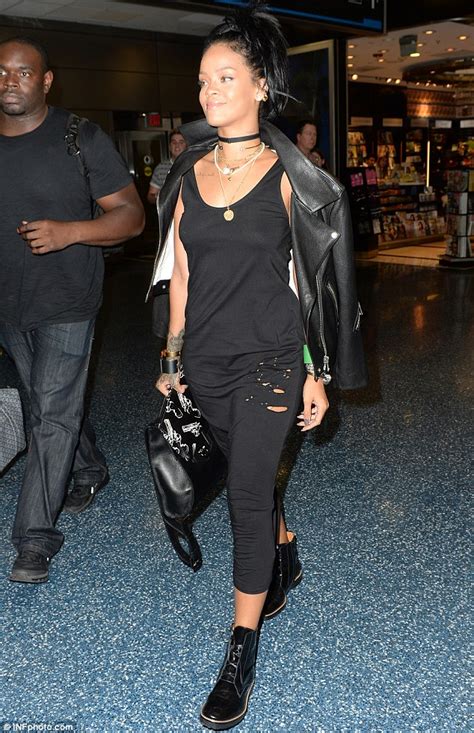 Rihanna Goes Braless In Clingy Black Dress As She Arrives In Miami