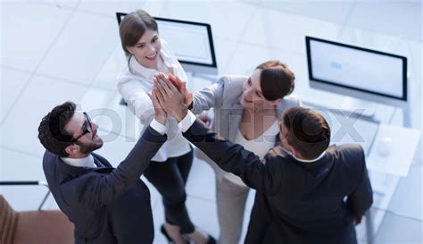Successful Business Team Giving Each Other A High Five Standing In The