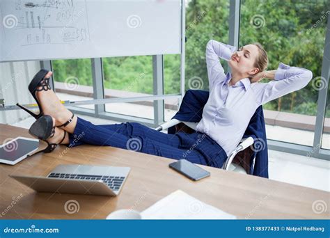 Female Office Worker Standing By Desk Smiling Royalty Free Stock Image