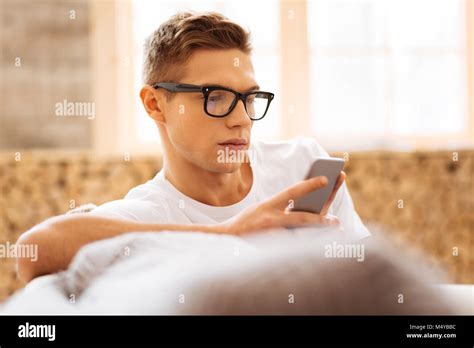 Unsmiling Teenager Using His Phone Stock Photo Alamy