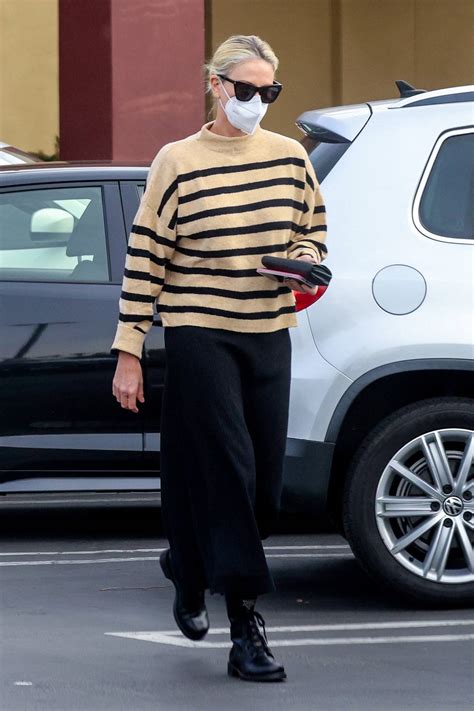 Charlize Theron Wears A Striped Sweater And Black Skirt While She Picks