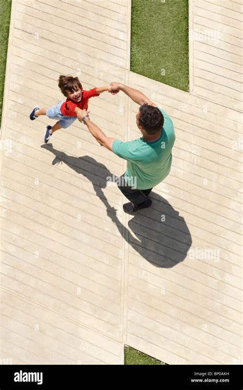 Father Swinging Son Around Stock Photo Alamy