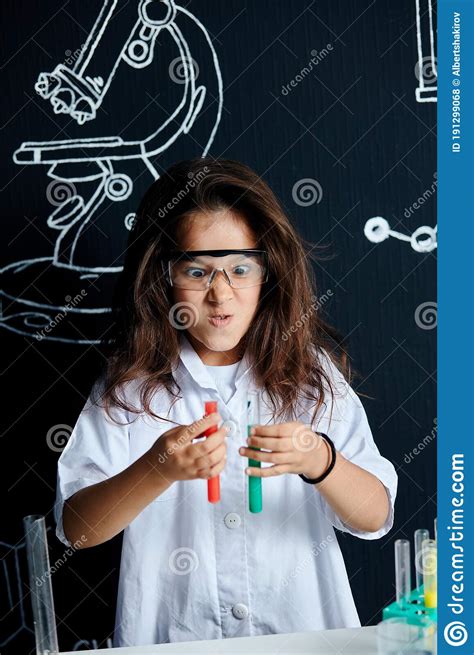 Asian American Female Child Scientist Holding Tube During A Experiment