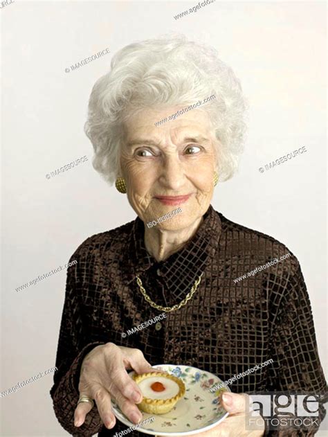 Senior Woman With Cherry Bakewell Tart Stock Photo Picture And