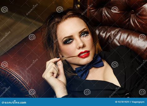 femme fatale on leather couch stock image image of beautiful couch 92781929