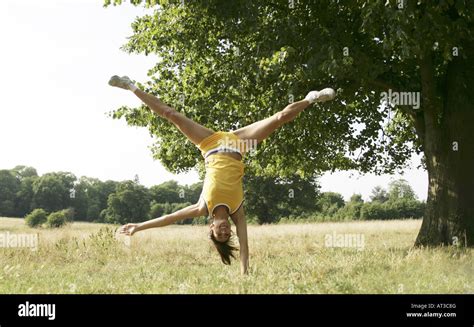 A Young Woman Doing A Cartwheel Stock Photo Alamy