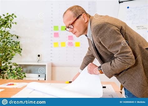 Contractor Analyzing Plan On Blueprint At Workplace Stock Image - Image ...