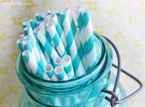 Several Blue And White Striped Straws In A Mason Jar