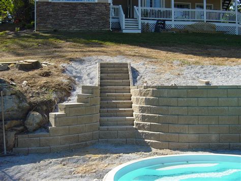Retaining walls often are used to manage steep slopes in a landscape. Stain Concrete Block Retaining Wall | Bindu Bhatia Astrology
