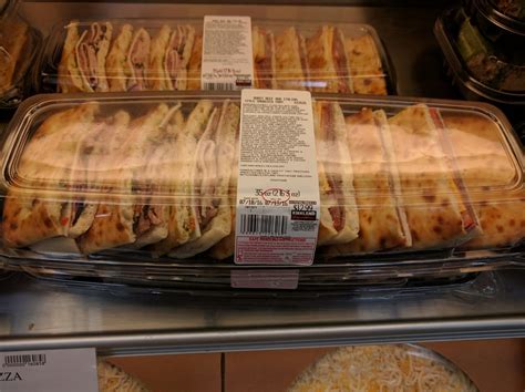 Costco catering menu includes big trays with sandwiches or wings. costco wraps platter