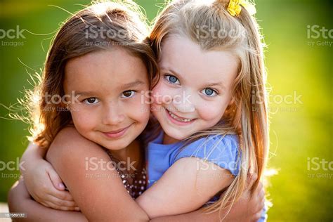 Two Happy Friends Hugging Each Other Outside Stock Photo Download