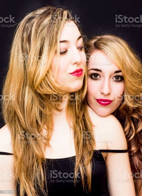 Two Beautiful Women Portrait Over Black Background Stock Photo