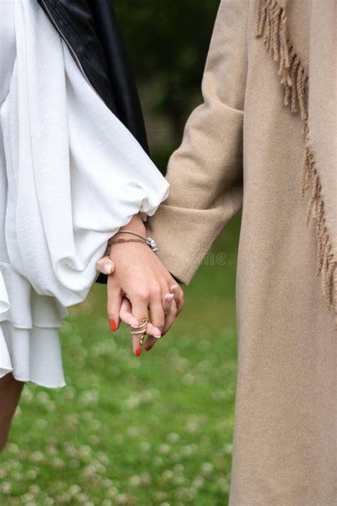 Close Up Of Two Women Holding Hands On The Grass Same Sex Love Concept Stock Image Image Of