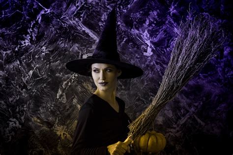 Premium Photo Halloween Witch Holding A Pumpkin And A Broom Woman Dressed Like A Fairy Witch
