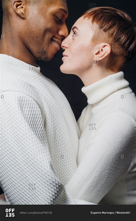 Studio Portrait Of Affectionate Mixed Race Couple Face To Face Stock