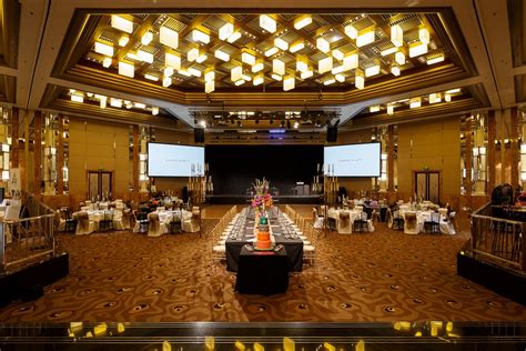 A Banquet Hall With Tables And Chairs Set Up For An Event