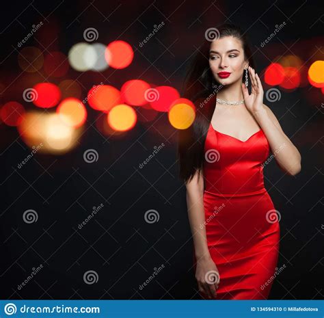 Fashion Model Woman In Red Silky Dress And Black Carnival Mask On