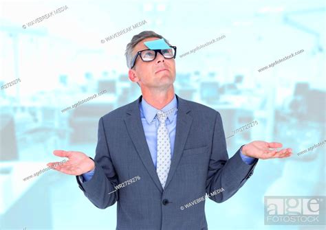 Businessman Gesturing With Sticky Note Stuck On His Forehead Stock Photo Picture And Royalty