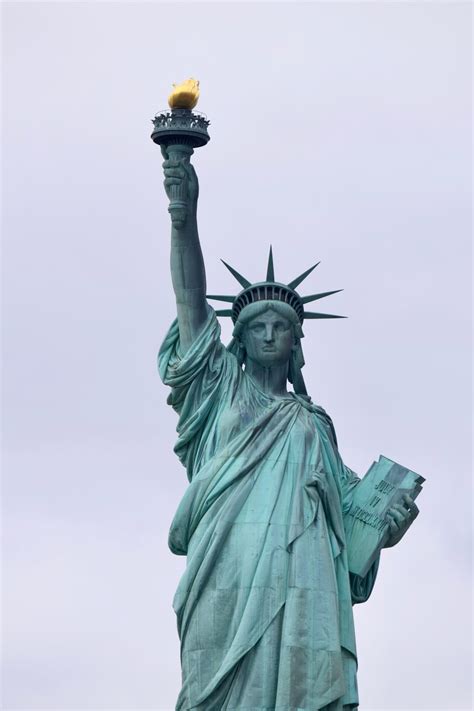 The statue of liberty is among new york city's—and america's—most familiar landmarks: Statue of Liberty, New York photo - Free Human Image on ...