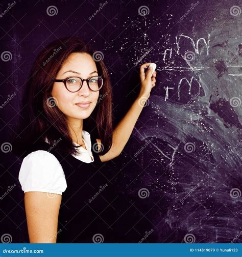 Portrait Of Happy Cute Student At Blackboard In Classroom Smiling Stock