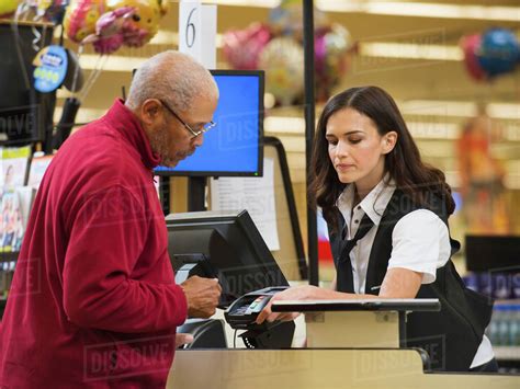 Cashier And Customer At Grocery Store Checkout Stock Photo Dissolve